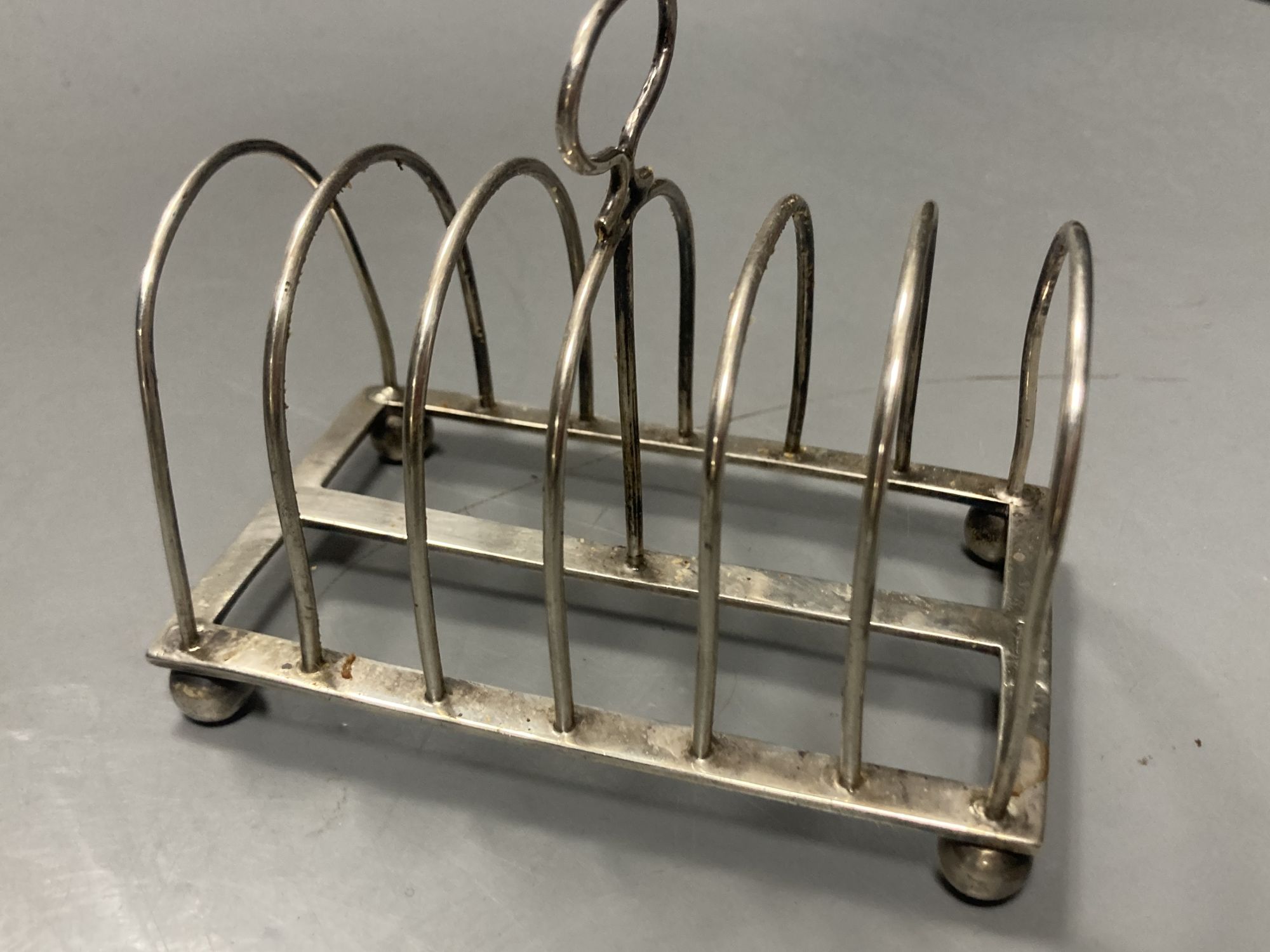 An Edwardian silver seven bar toastrack, William Hutton & Sons, Sheffield, 1909, a.f., a pair of George III silver salts etc.